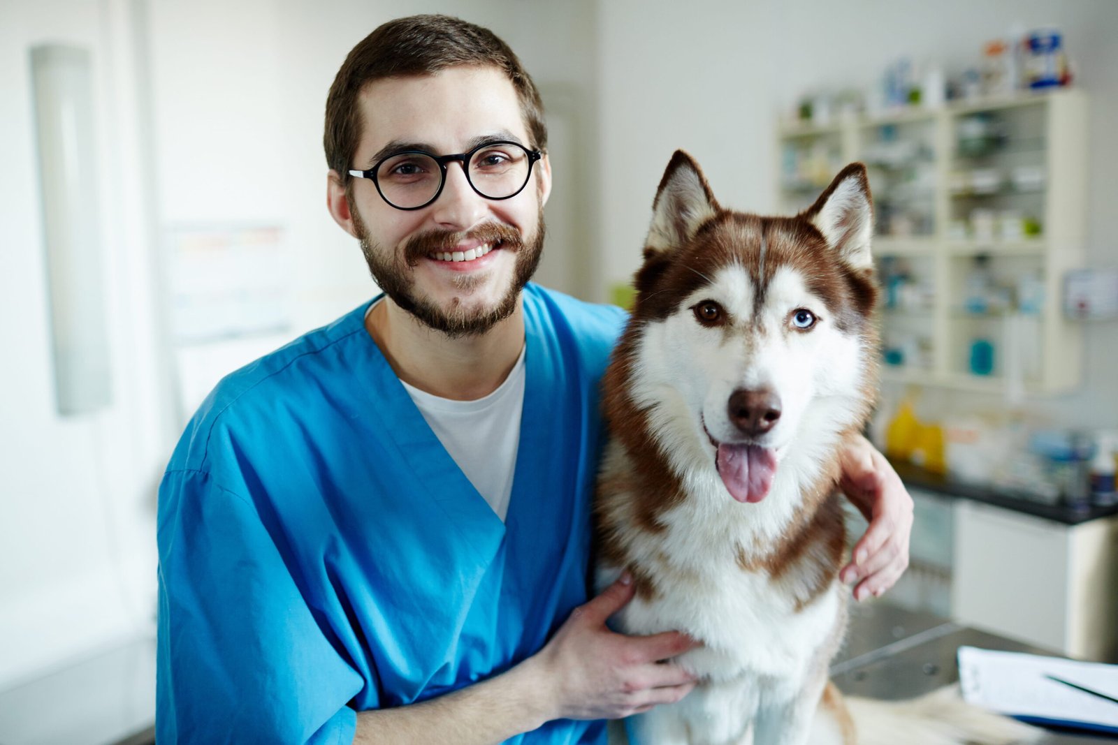 bearded-man-smiles-with-dog-in-veterinary-office-2026-01-09-09-26-53-utc (1)